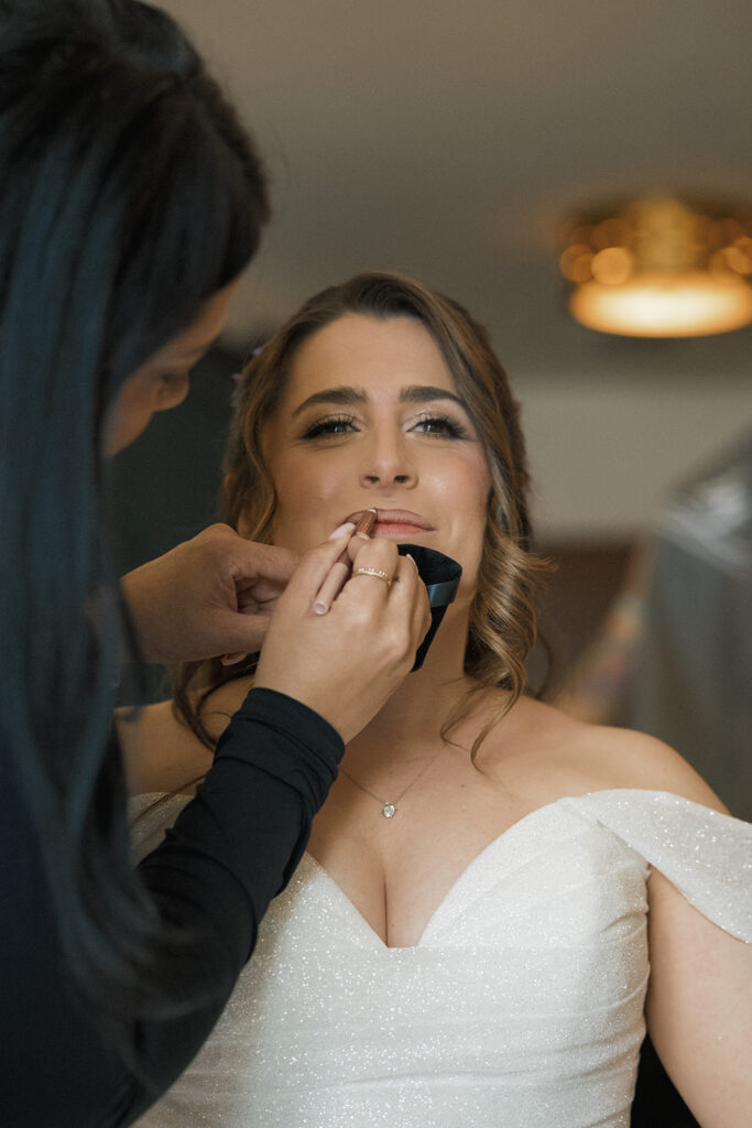 bride gets makeup done