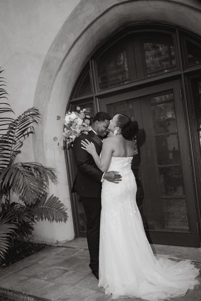 Newly married couple laughing together during a candid Bok Tower Gardens elopement session