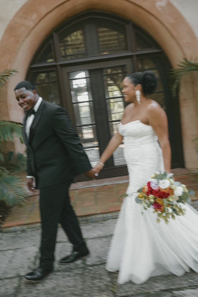 Newly married couple walking together during a candid Bok Tower Gardens elopement session