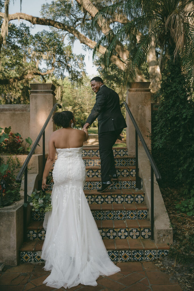 Casey and Nick walking up the stairs outside El Retiro at Bok Tower Gardens during their elopement photos