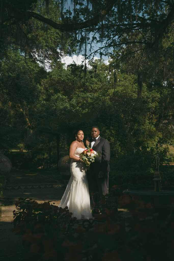 Casey and Nick posing in golden hour light outside El Retiro at Bok Tower Gardens during their elopement photos